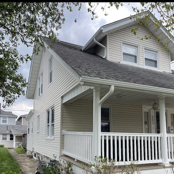 Same home — wider angle showing porch and roofline