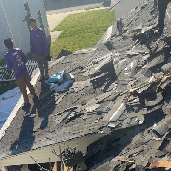 Crew stripping the old shingles off the Bradley Beach roof