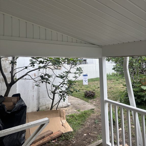 Rebuilt porch overhang in Bradley Beach NJ with new white solid soffit and wrapped posts