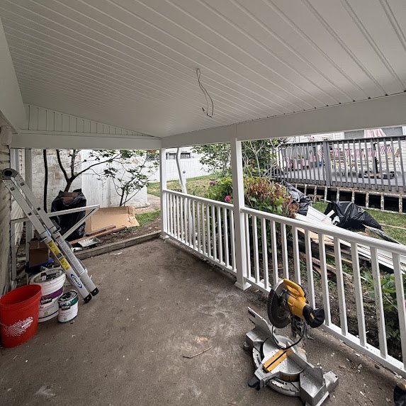 Porch during overhang rebuild with new white solid soffit ceiling