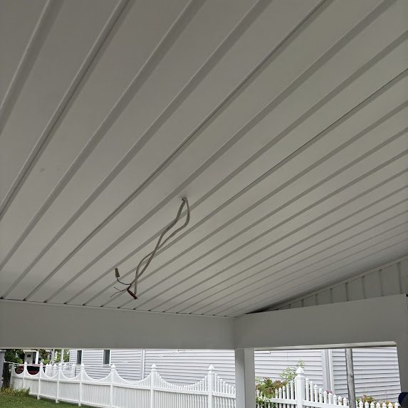 New white solid soffit panels on a rebuilt overhang ceiling