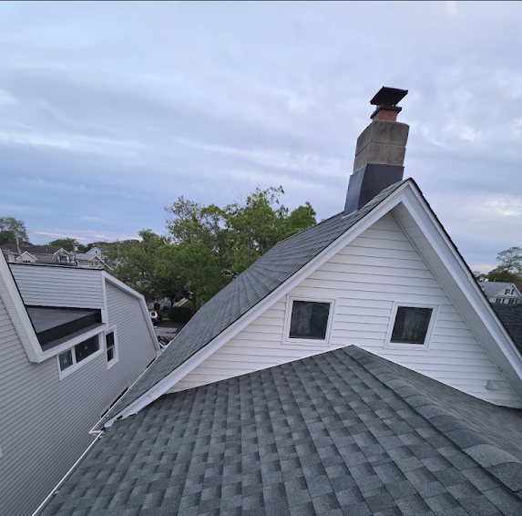Finished GAF Pewter Gray shingle roof with a brick chimney on a home in Bradley Beach NJ