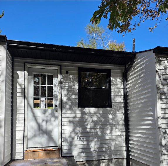 Black gutter above a side entry door and window on a new-construction home in Brick NJ
