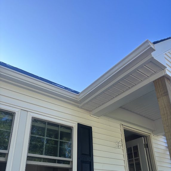 New white gutter wrapping the porch roofline of a new construction home