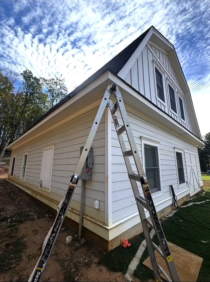 Ladder set up beside a renovated barn-style home in Colts Neck before gutter installation