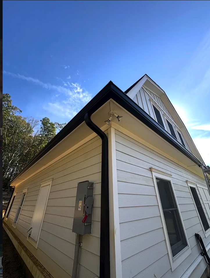 Black 6-inch K-style gutter and downspout on a renovated white barn-style home in Colts Neck NJ