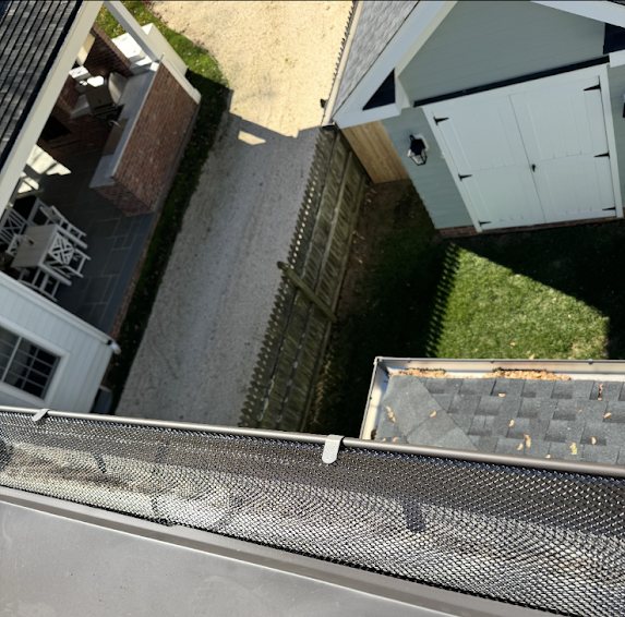 Gutter guard installed along a back gutter above a patio and shed in Fair Haven NJ
