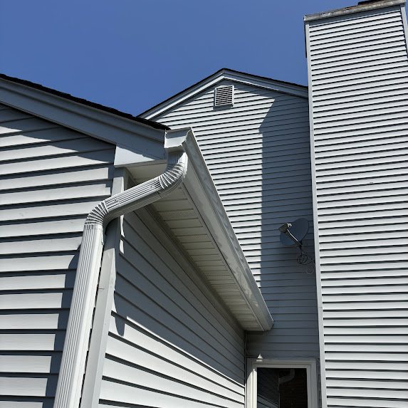 White downspout at a gable on a Freehold NJ home with new gutters