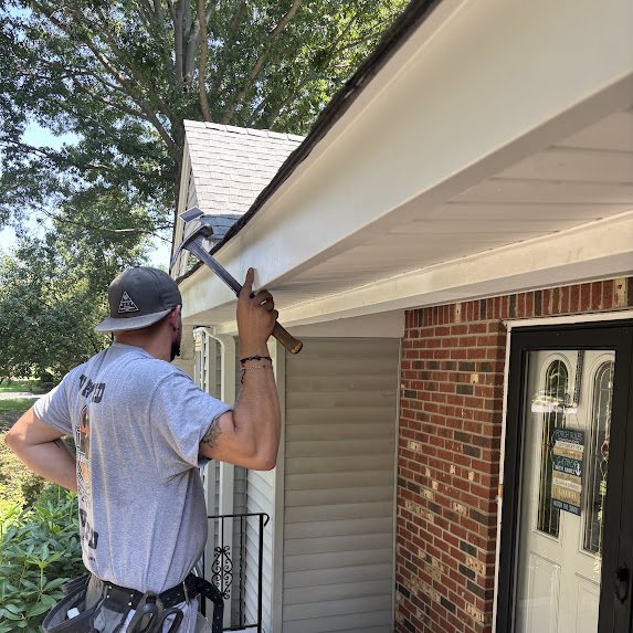 Installer working on new white fascia ahead of a 6-inch gutter install in Freehold