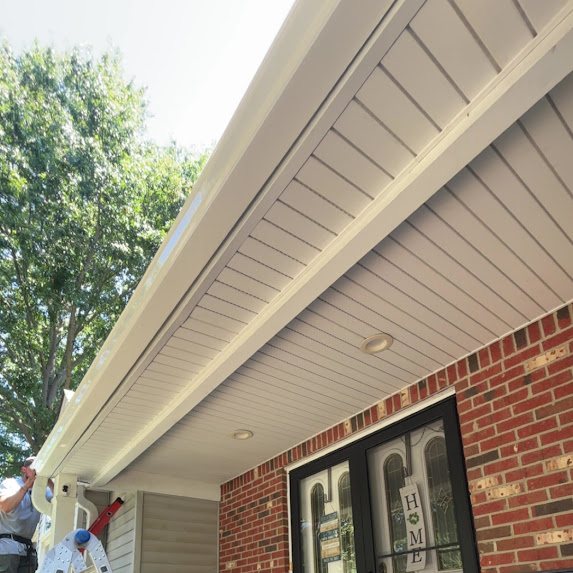 New hidden-vent soffit and 6-inch gutters on a brick-front porch in Freehold NJ