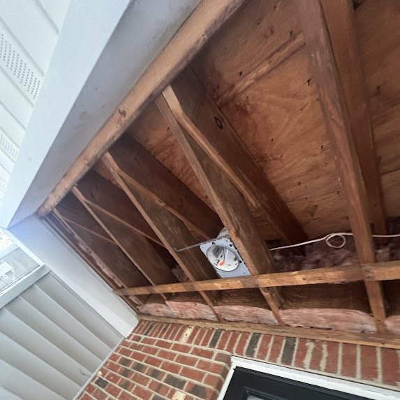 Porch overhang opened to bare framing during soffit replacement in Freehold NJ