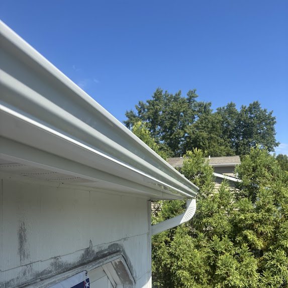 New white 6-inch K-style gutter and downspout on a white home in Freehold Township NJ