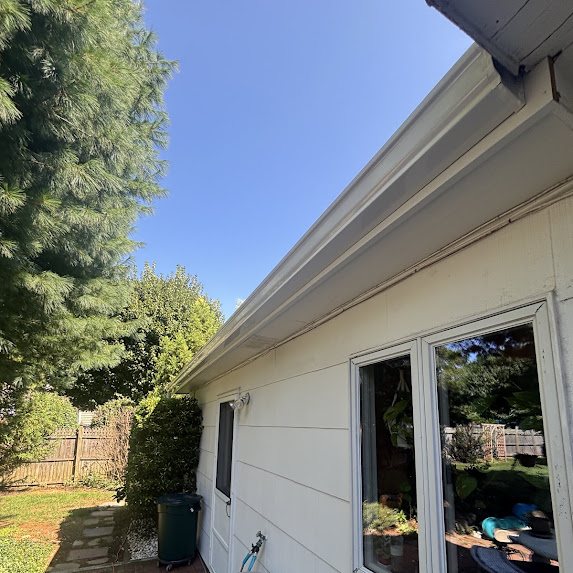 New white gutter and wrapped fascia above sliding patio doors