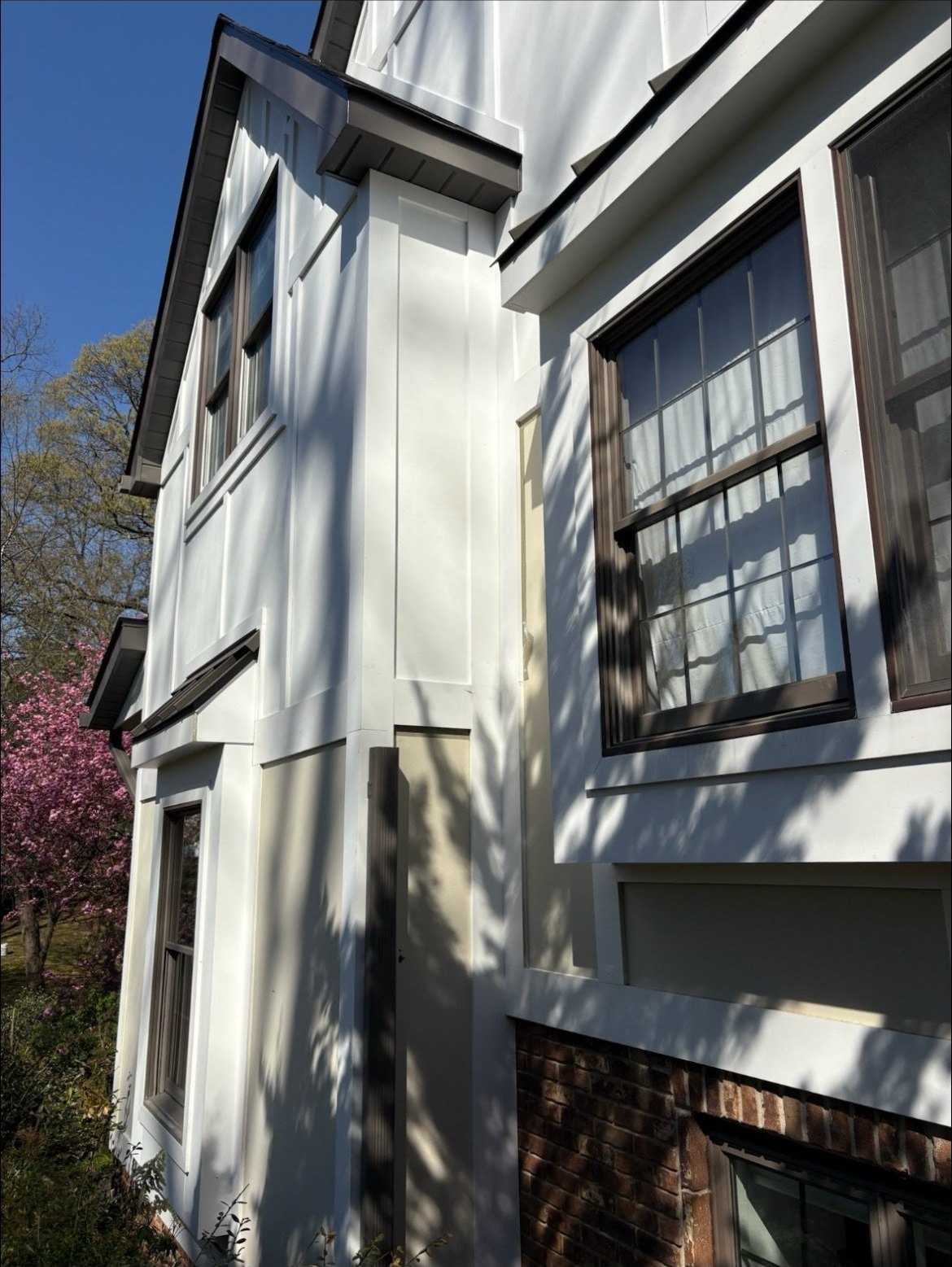 Dark 6-inch colored gutters against white board-and-batten siding in Holmdel, NJ