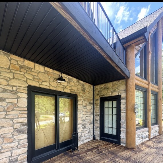 Black soffit and J-channel installed under the deck at JR’s Cattle Ranch log cabin in Millstone Township