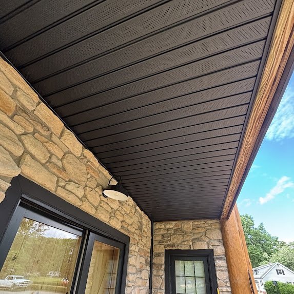 Black soffit underside view with black gooseneck light fixture