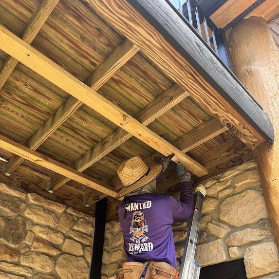 Soffit framing detail under the log cabin deck before panels
