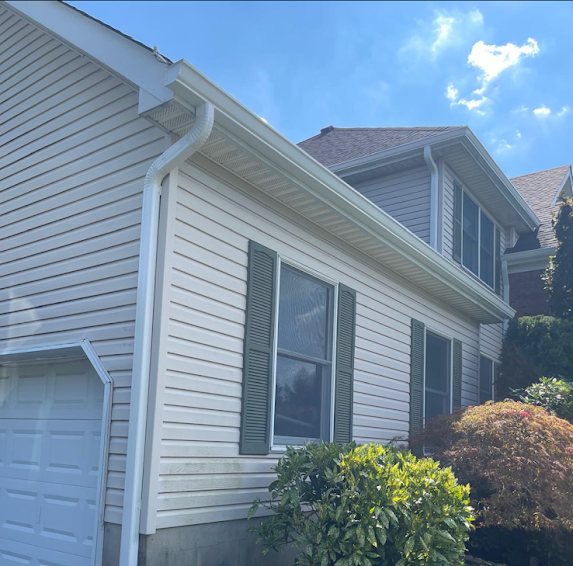 New white 6-inch K-style gutters and downspout on the garage side of a Marlboro NJ colonial