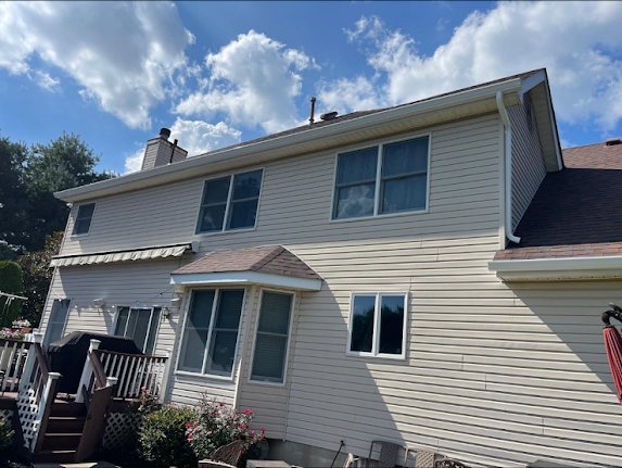 Rear elevation of a Marlboro colonial with new white seamless gutters