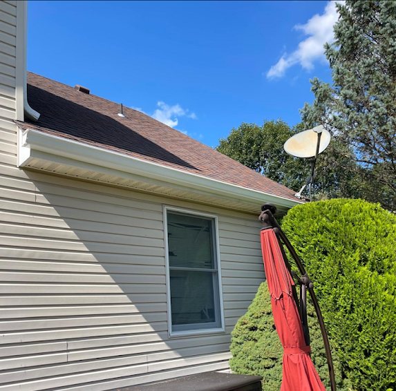 New white gutters along a rear gable and dormer of a Marlboro NJ home