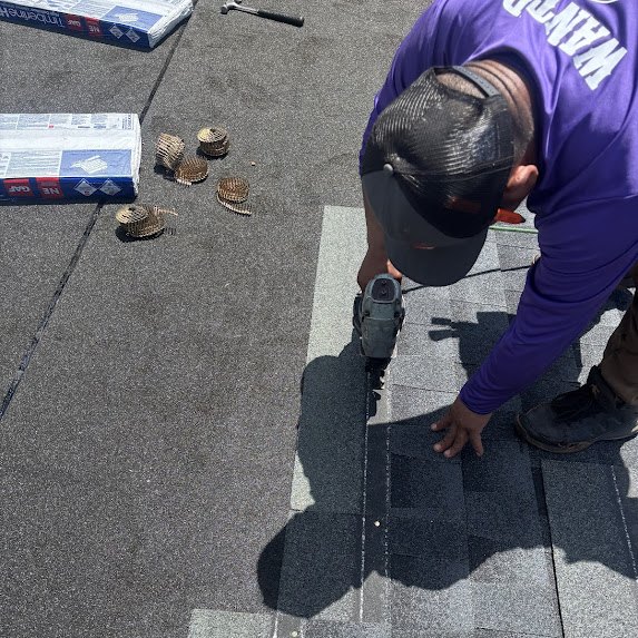 Installer nailing GAF Timberline HDZ shingles on a Millstone Township roof