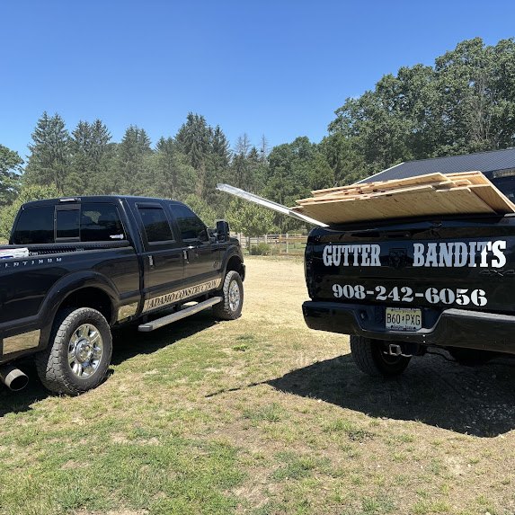 Gutter Bandits truck loaded with new plywood for roof decking replacement