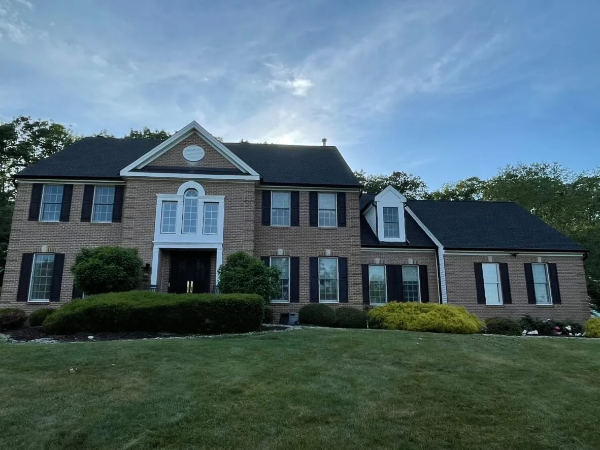 Millstone Township Brick Colonial: Black Gutters That Sharpen the Whole Front