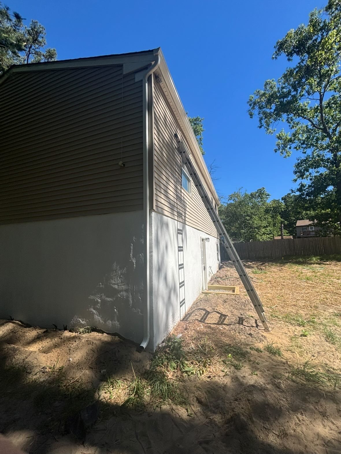 White downspout at the gable end of a Millstone Township ranch