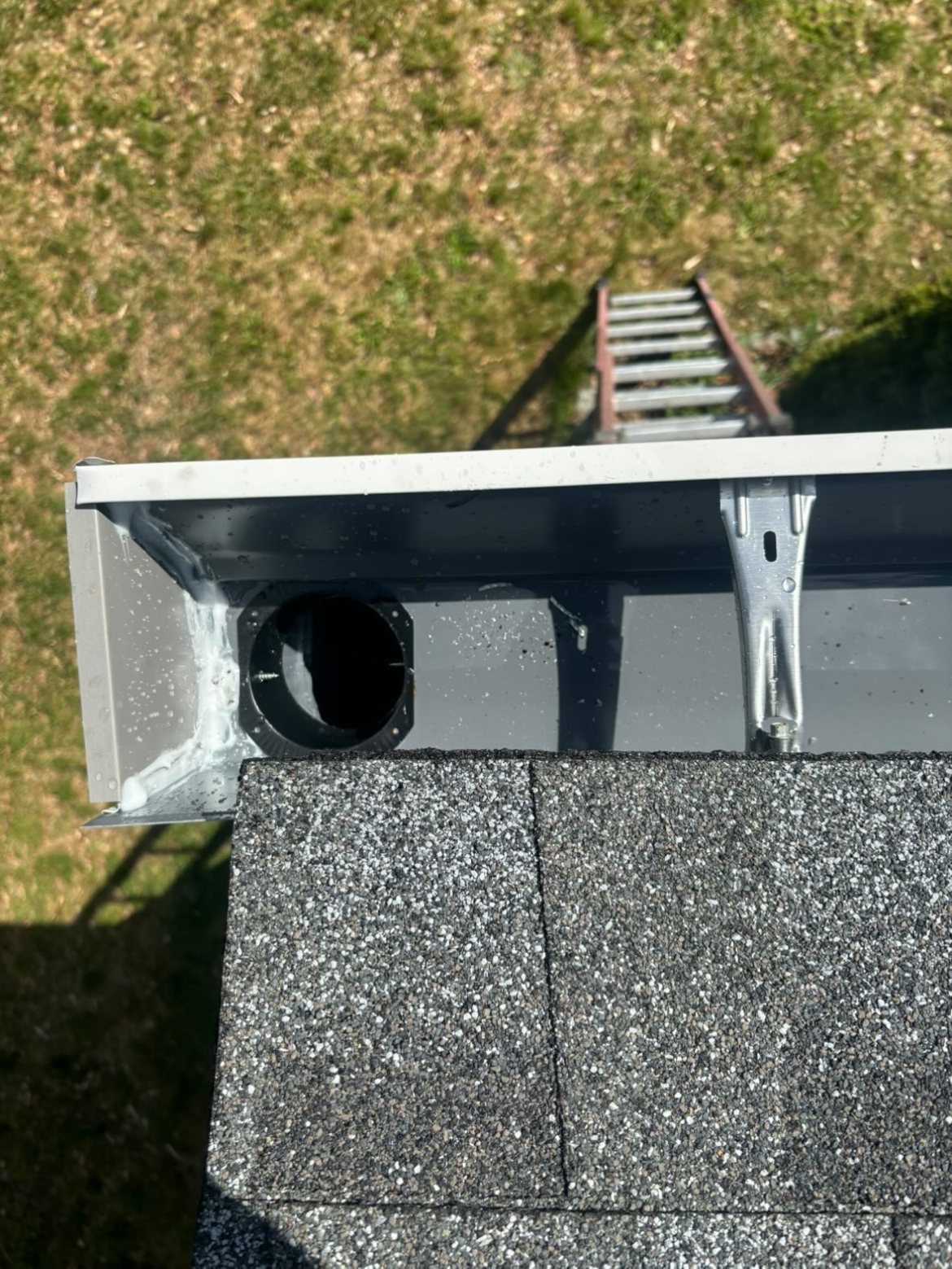 Top-down view of a black gutter outlet drop box detail