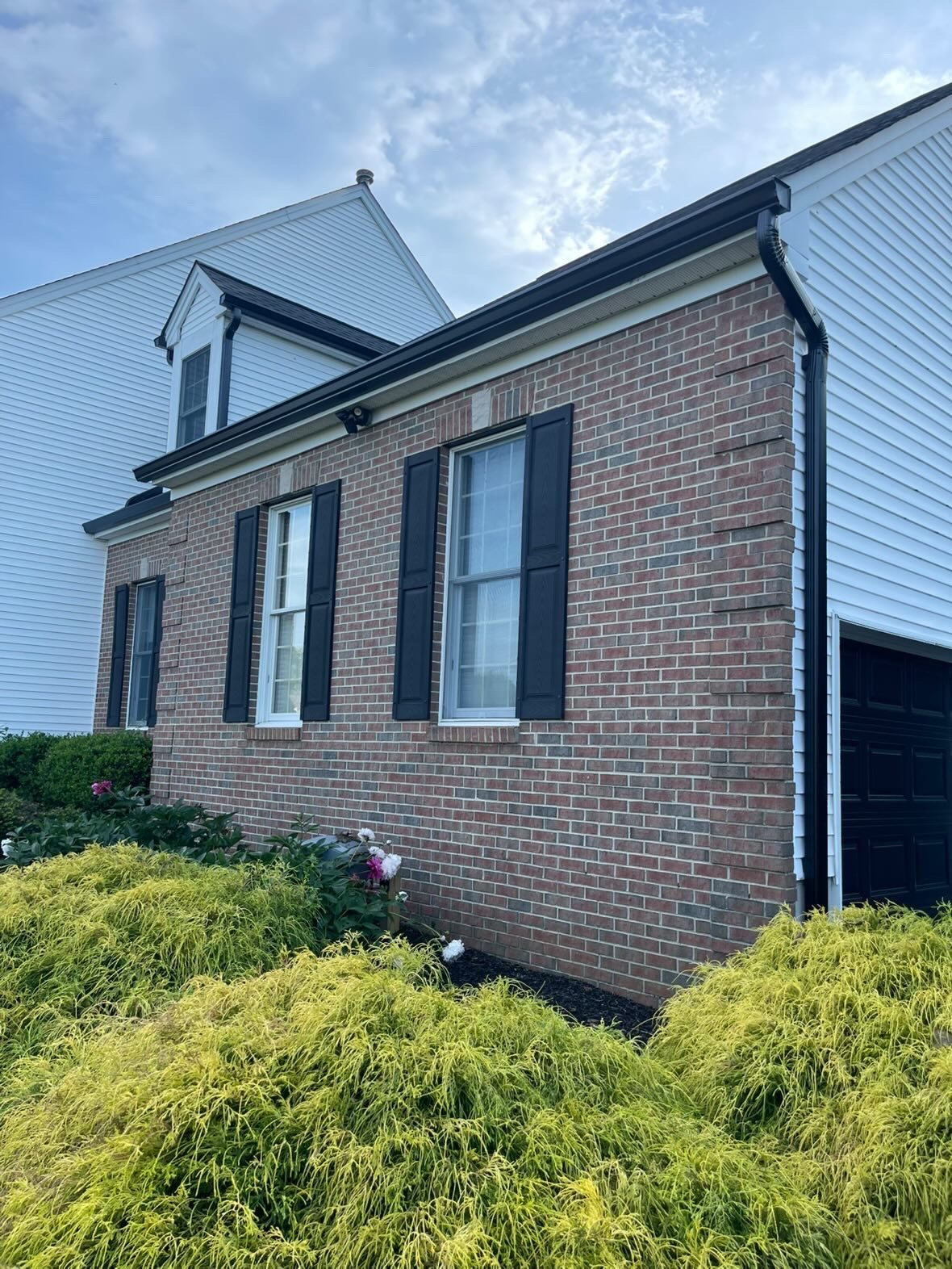 Black corner downspout on a white colonial in Millstone Township