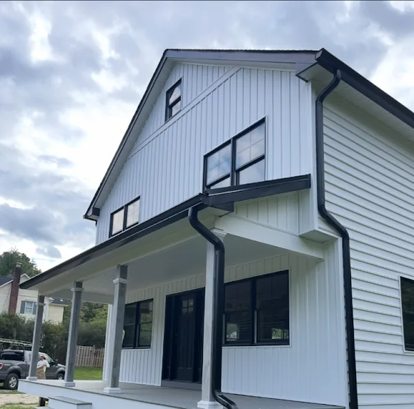 Morganville New Construction: Black 6-Inch K-Style Gutters and 3x4 Downspouts on a Modern Farmhouse