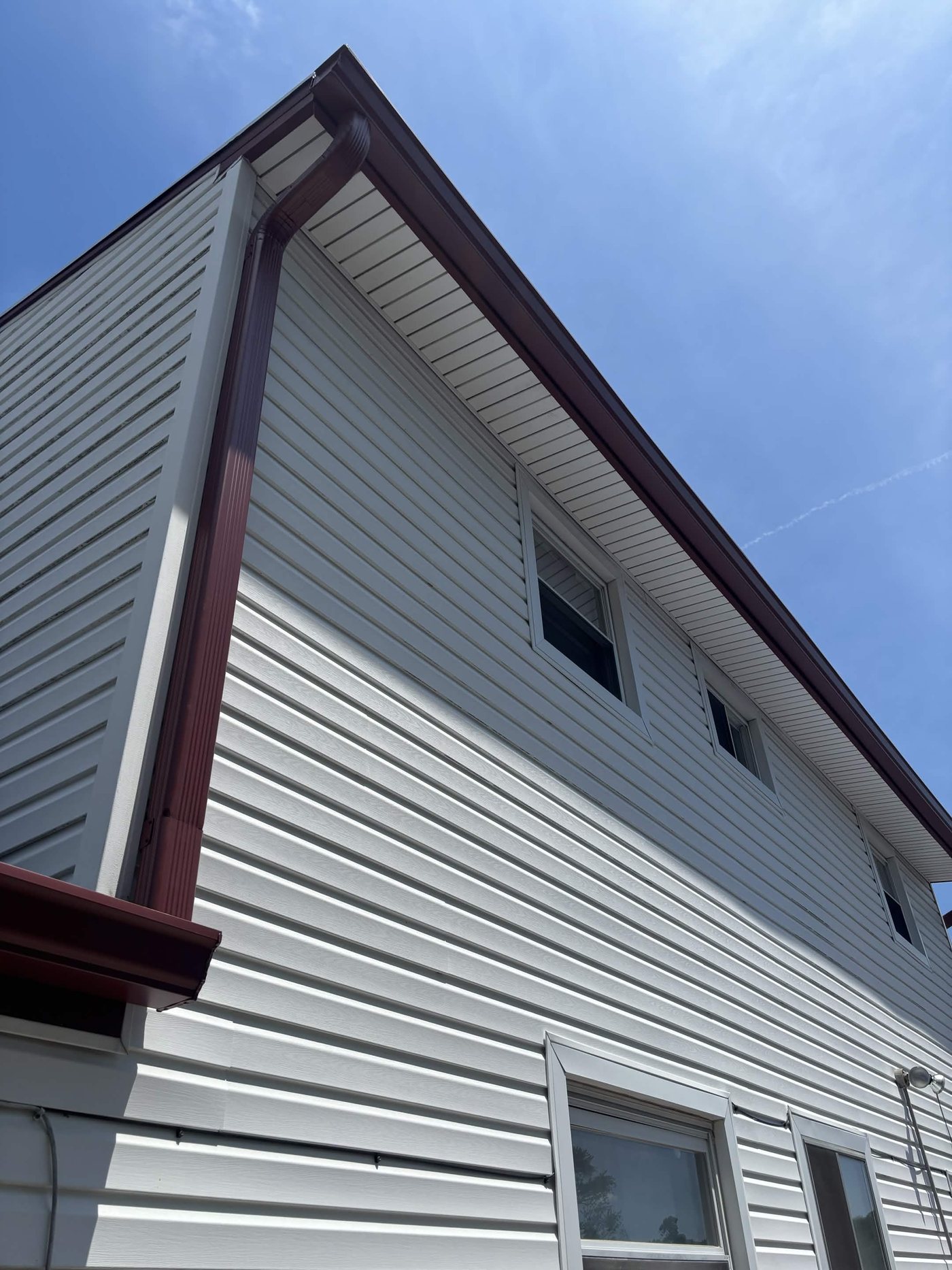New Scotch Red 6-inch seamless gutter and downspout on a white two-story colonial in Old Bridge, NJ