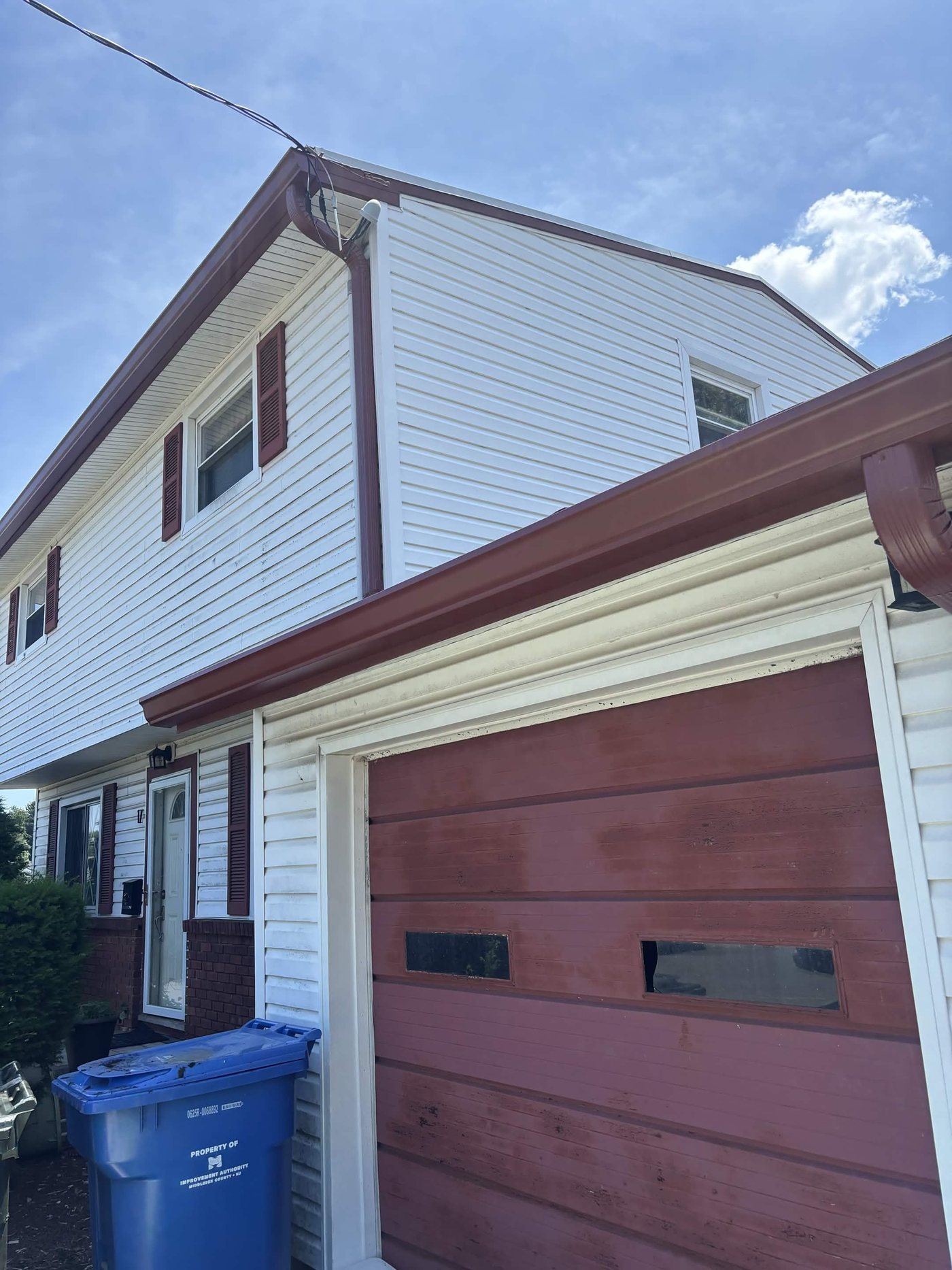 White two-story colonial in Old Bridge with new Scotch Red gutters