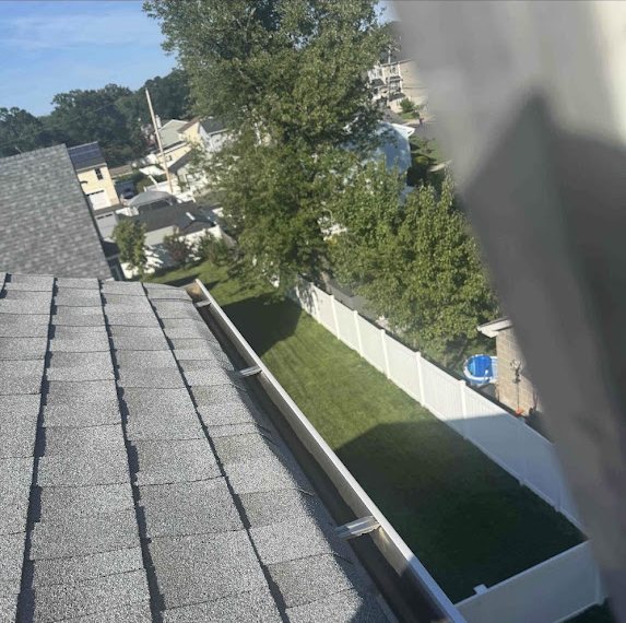 Cleaned open gutter along a roof edge in Port Monmouth before guard installation