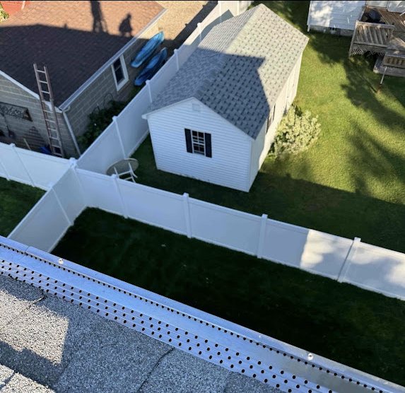 New perforated RX aluminum gutter guards installed along a roof edge in Port Monmouth NJ
