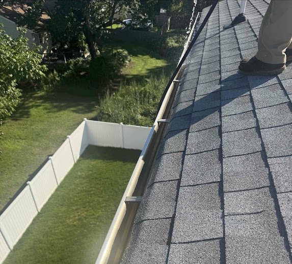 Open cleaned gutter with hangers visible during a guard installation