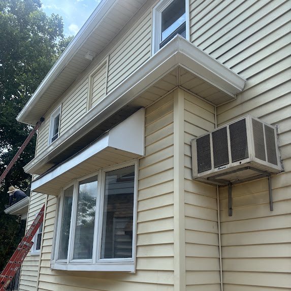 Side of a renovated Riverside NJ home with new white gutters
