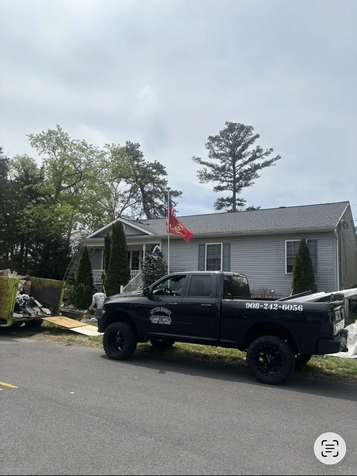 Gutter Bandits truck on-site, dumpster staged, materials staged for tear-off
