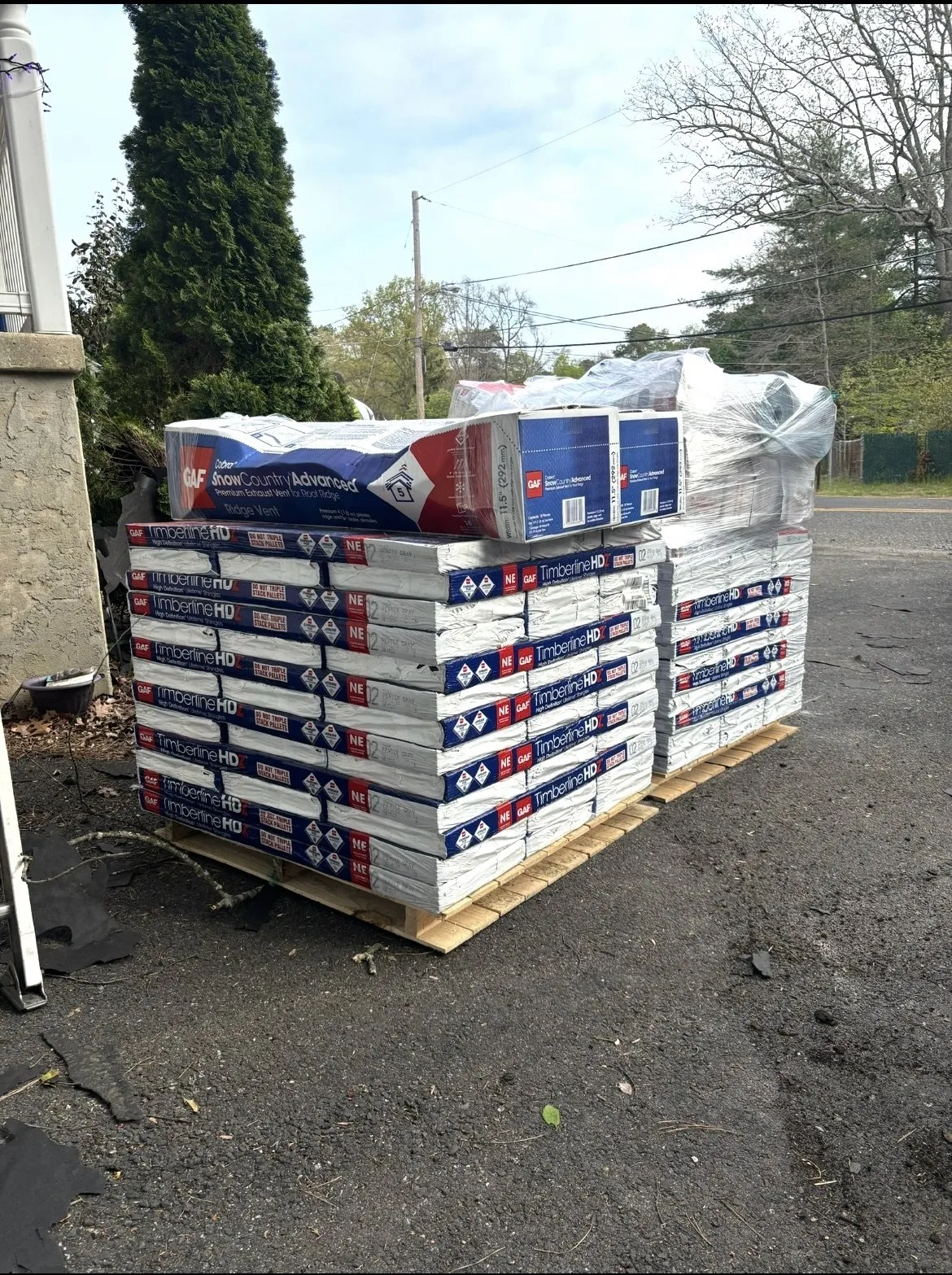GAF Timberline HD architectural shingles and Cobra Snow Country Advanced ridge vent staged on pallet