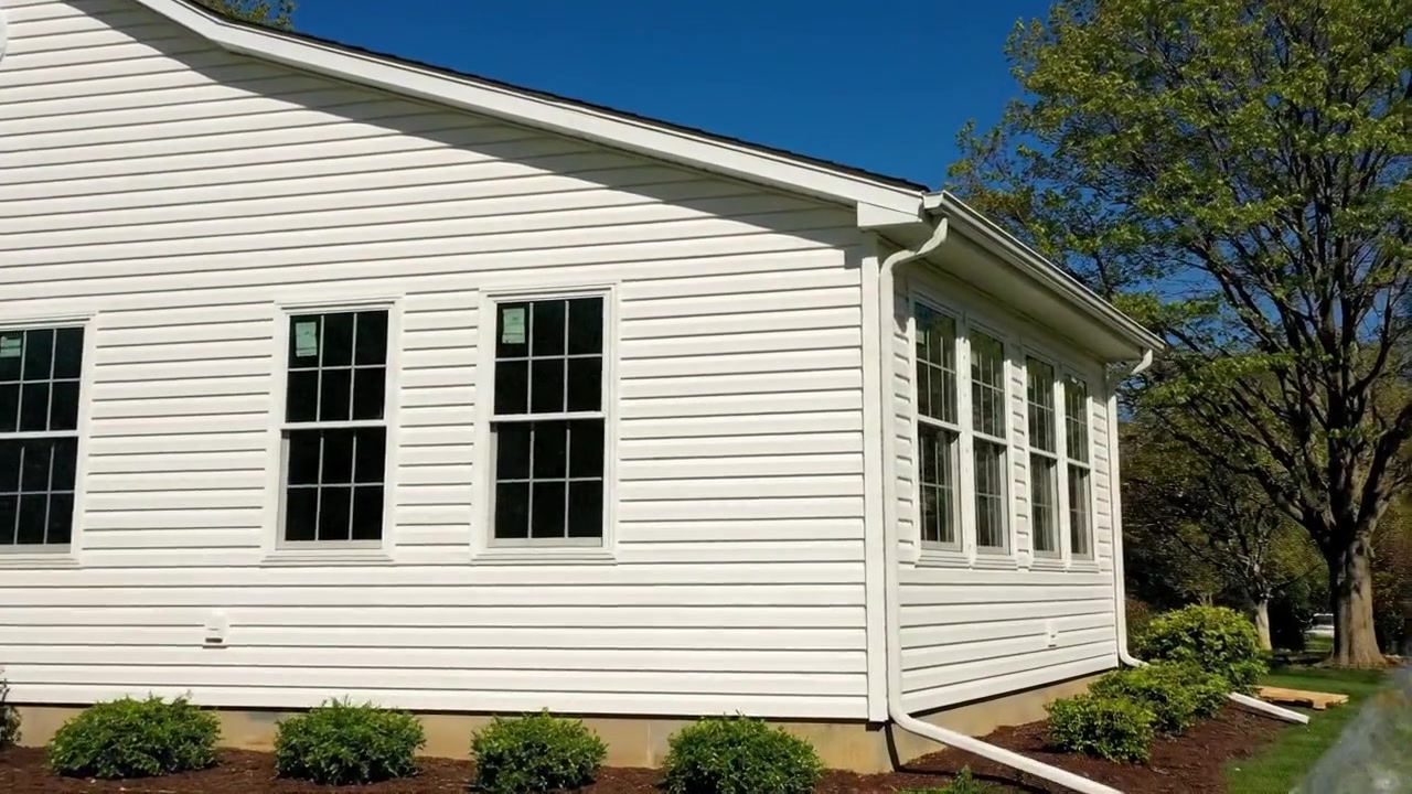 Completed white vinyl siding on Millstone Township sunroom