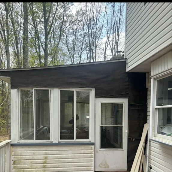 Weathered dark siding on Millstone Township sunroom before replacement