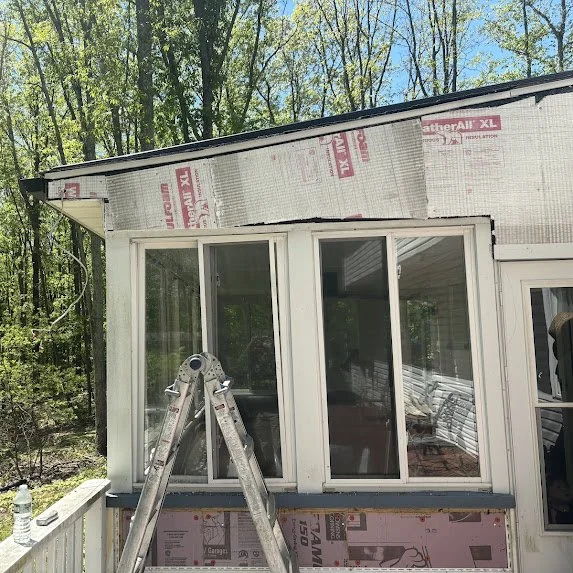 Insulation board exposed during siding replacement on Millstone Township sunroom