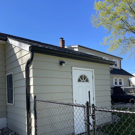 Side elevation showing the clean black gutter line and downspout
