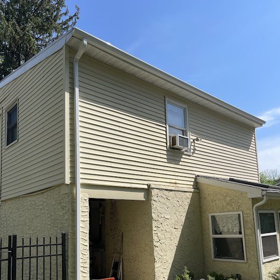 Two-story rear view — fresh seamless gutters fully installed